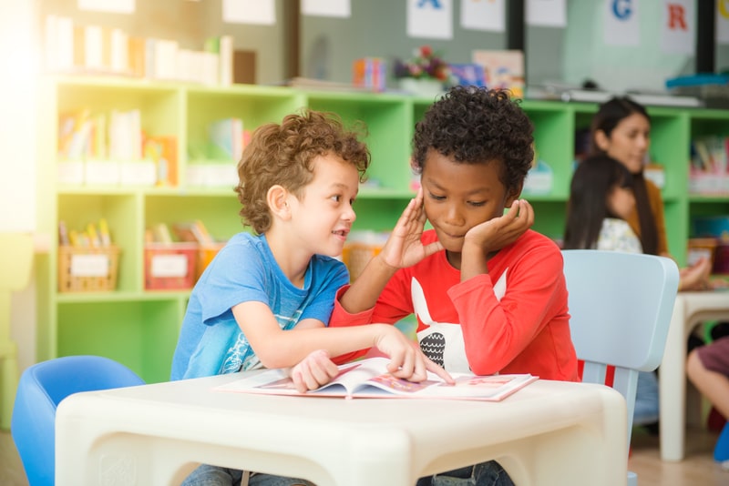 two young boys reading together