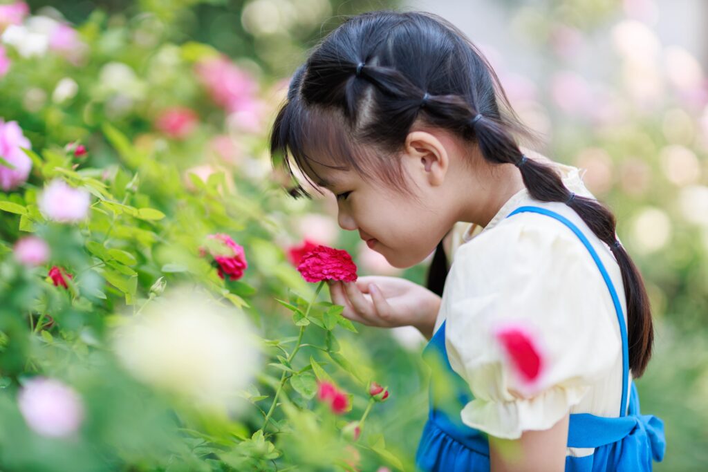 girl smelling flowers