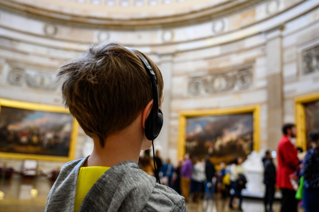 boy listening to guided tour
