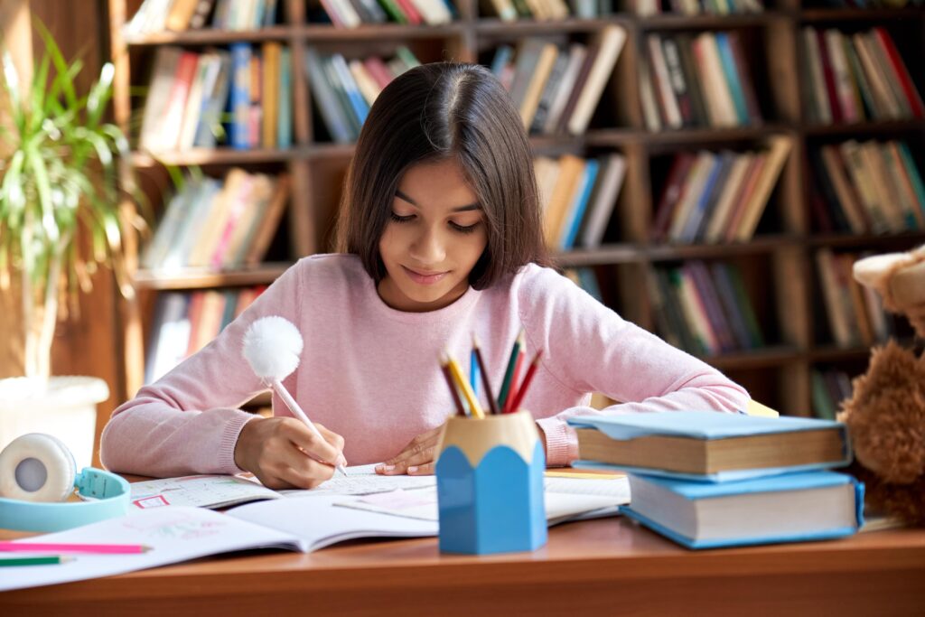 young girl working on school work at home