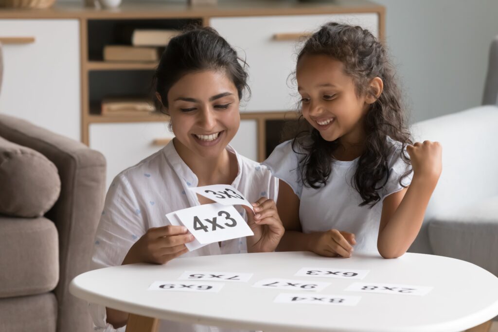 mom and daughter using flashcards