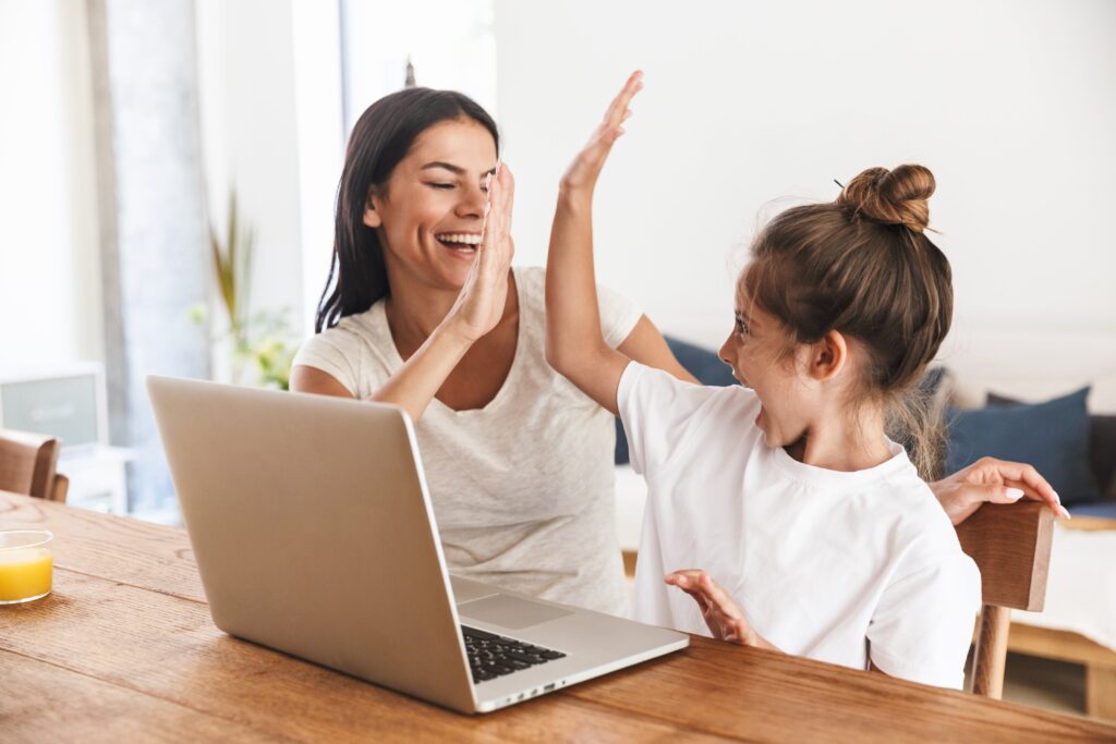 Mother and daughter high-fiving