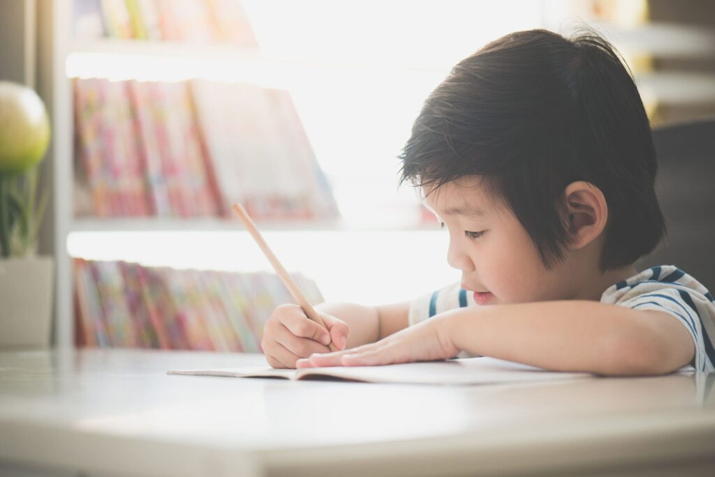 young boy writing
